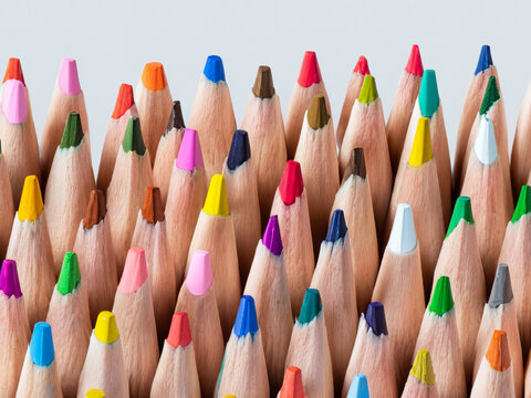 many colored pencils on a white background