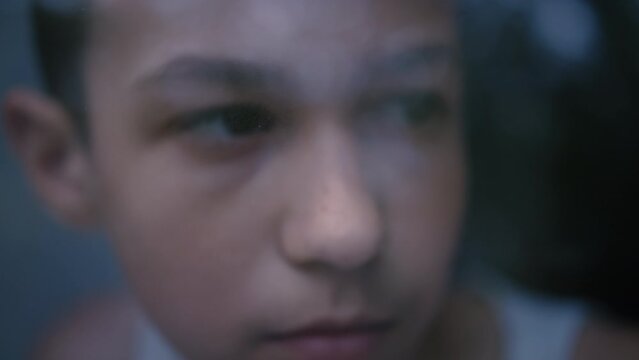 Soulful Regret: Close-Up of a Boy Lost in Profound Sorrow