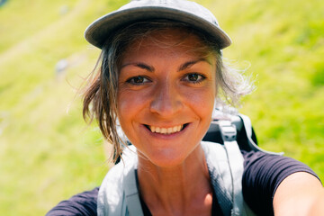 happy hiker woman taking selfie in the mountains. close up