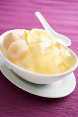 Taiwanese food - delicious cold drinking dessert Aiyu ice jelly in a white bowl on purle background