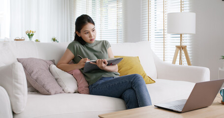 Fototapeta premium New possible career digital transformation future workforce class. Asia people young girl talent woman sit relax work at sofa home office study MBA reskill upskill job course remote live video call.
