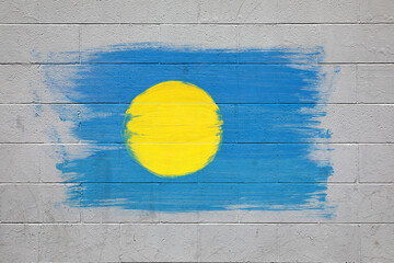 Palau flag colors painted on brick wall