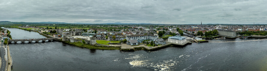 Fototapeta na wymiar Aerial view of Limerick city on the banks of the Shannon river with the Thomond bridge, King John's castle, King's island, abbey