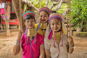 portrait of Karen women from Pai at Mae Hong Son, Thailand sitting on wooden swings