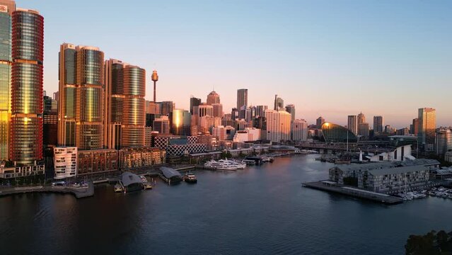 Sydney, Australia: Aerial drone footage of the Darling Harbor newly redeveloped district in downtown Sydney at sunset in Australia largest city with a forward motion