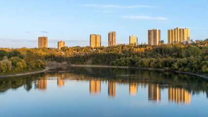 City of Edmonton river valley landcape with golden hour light and water reflection mix of blue and yellow colours