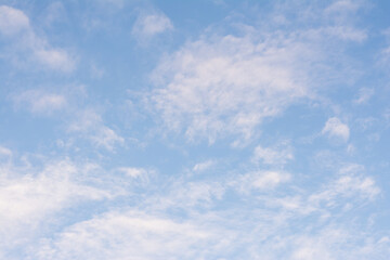 Blue sky background with tiny clouds