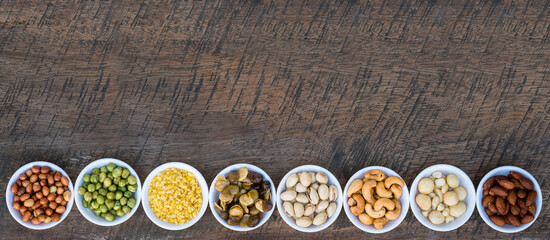 Mixed nuts in bowl on plank wood background, Healthy snacks food.