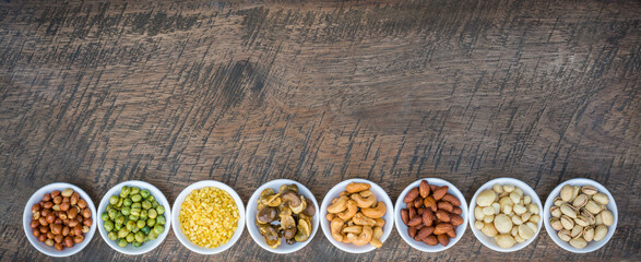 Mixed nuts in bowl on plank wood background,Healthy snacks food.