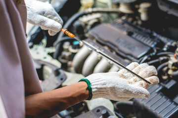 Repairman Checking Engine Oil Level .Repair Service