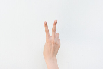 Women showing finger on white background.Counting number two.