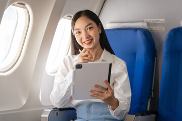 Using tablet pc, Thoughtful asian people female person onboard, airplane window, perfectly capture the anticipation and excitement of holiday travel. chinese, japanese people.