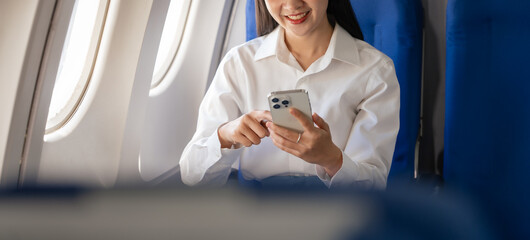Obraz na płótnie Canvas Texting on mobile chat app, Thoughtful asian people female person onboard, airplane window, perfectly capture the anticipation and excitement of holiday travel. chinese, japanese people.