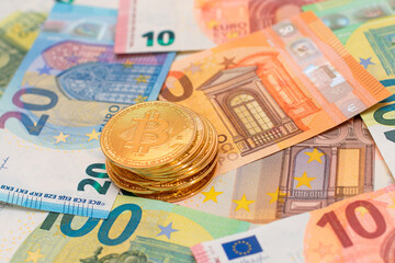 A Stack of Bitcoin Coins on the Euro Banknotes. Money Saving, Cryptocurrency, Blockchain and Anonymous Payments Concept