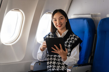 Passionate female asian chinese japanese people student aboard airplane, clutching textbooks, eagerly anticipating her overseas academic venture.