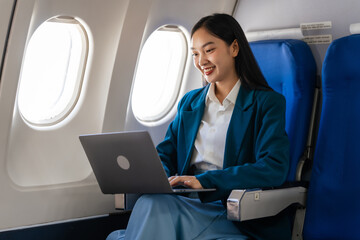 Young asian chinese japanese people female adventurer in-flight, mapping out destinations as she...