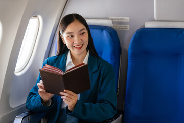 Young asian chinese japanese people female adventurer in-flight, mapping out destinations as she voyages worldwide. woman passenger of airplane. travel around the world.