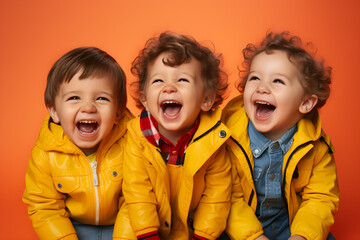 portrait of 3 happy little boys, smiling and laughing, wearing bright colourful clothes. bright solid orange colour background