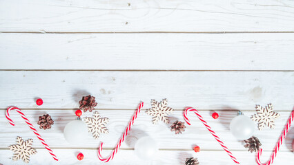 Christmas background. Candy cane and christmas decoration on a light wooden background....