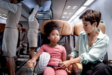 Curly hair African girl child passenger feeling anxious and worry about traveling by plane, parent...