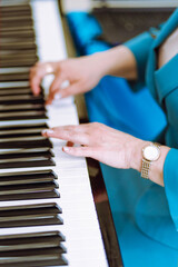Close up fingers of pianist at the piano keys. Woman arms plays solo of music or new melody. Hands...