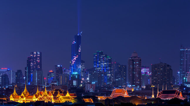 grand palace and wat phra kaew in Bangkok city with sunset sky from roof top of building
