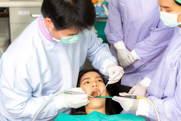 Asian woman decayed tooth operation in dental clinic with her dentist