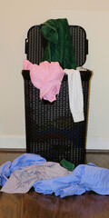 Dirty clothes overflowing a laundry basket