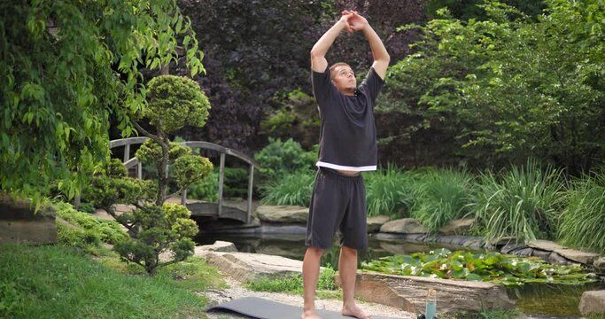 Healthy african american man exercising ar park outdoor practicing yoga
