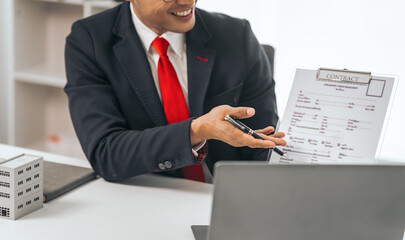 Agent presents contracts for property purchase or lease. Businessman asian indian people showcases...