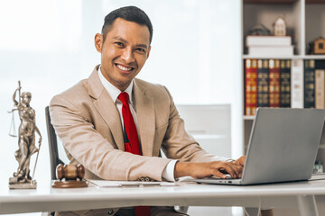 Middle-aged Asian indian people male lawyer meticulously reviews legal documents. Courtroom judge...