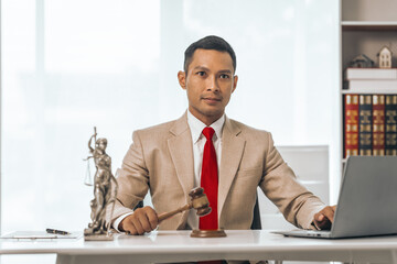 Middle-aged Asian indian people male lawyer meticulously reviews legal documents. Courtroom judge...