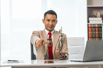 Middle-aged Asian indian people male lawyer meticulously reviews legal documents. Courtroom judge...