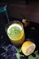 cold water with a slice of lemon fruit and mint leaf