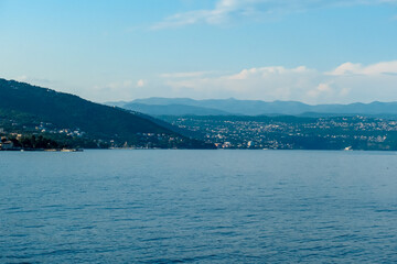 A panoramic view on the coastal line of Croatia. The Mediterranean Sea is calm and clear. There are forest and numerous small towns along the shore. Summer destination. Holidays vibes.
