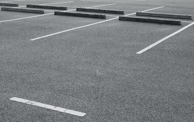 Empty parking lot with white marking lines. - obrazy, fototapety, plakaty
