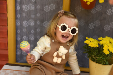 girl with flowers in the garden. little girl with a bouquet of flowers