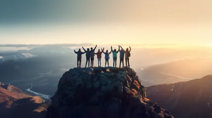 Rolgordijnen The idea of teamwork is illustrated as friends join hands near the mountain's peak © Vlad