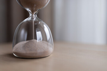 Hourglass on the table for business deadline. Time concept