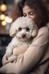 young woman holding his favorite pet poodle. friendly atmosphere.