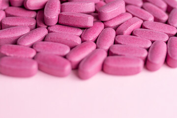 Obraz na płótnie Canvas Vitamins and supplements for women on a pink background. Top view, flat lay. 