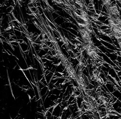 Wrinkled plastic wrap texture on a black background wallpaper. Royalty high-quality free stock photo image of realistic plastic wrap for overlay, copy space and photo effect. Wrinkled plastic surface