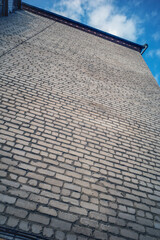 A fragment of a brick wall on an autumn day
