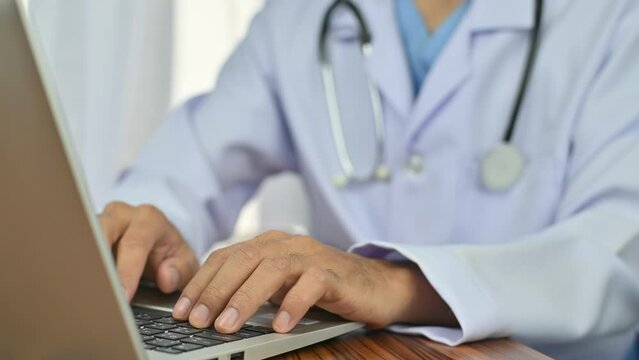Doctor using computer Document Management System (DMS), online documentation database process automation to efficiently manage files