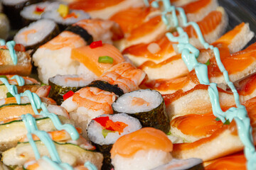 detail shot of a plate of sushi and canapés