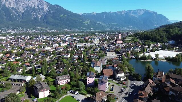 View of the Swiss city Werdenberg. Swiss Alps in the background. Roofs of houses and a city landscape from a quadrocopter. Beautiful mountains.