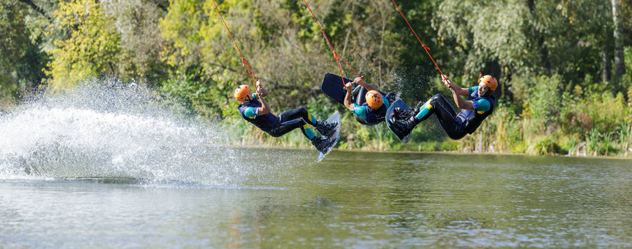 Sportsman on wakeboard performing back roll inversion on the river