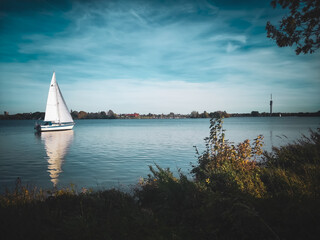A yacht sails on a river in Germany