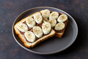 Sandwich with chocolate paste, banana and chia seeds. Breakfast. Vegetarian food.