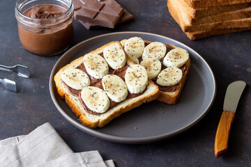 Sandwich with chocolate paste, banana and chia seeds. Breakfast. Vegetarian food.